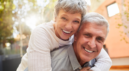 Loving mature couple sitting outside on a sunny afternoon